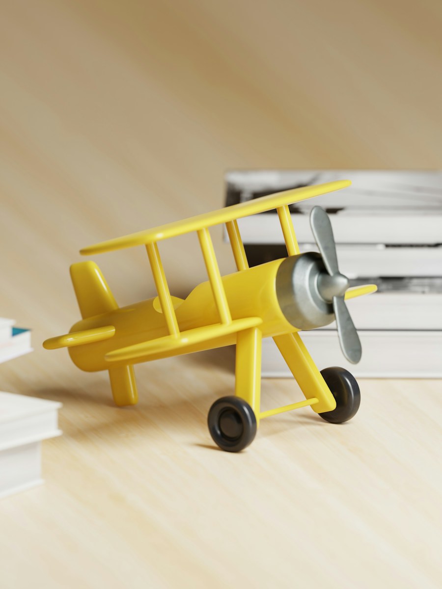 Yellow toy biplane with a silver propeller and black wheels